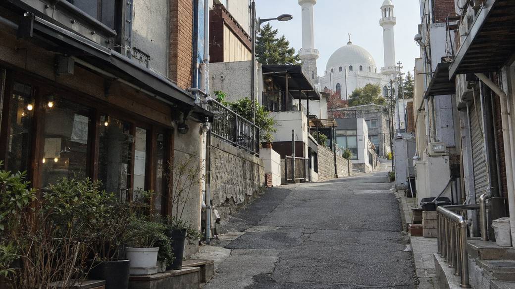 Usadan-ro 10-gil in Itaewon, Seoul: a sloping street of small restaurants leading up to the white domed Seoul Central