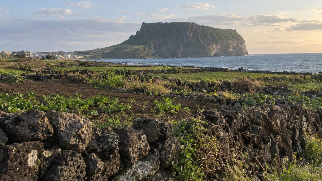 Seongsan Ilchulbong on Jeju's east coast seen across fields